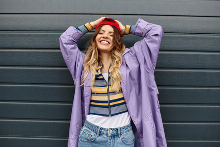 A young beautiful woman exudes happiness while wearing a colorful outfit and enjoying summer vibes.の写真素材