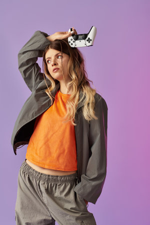 A stylish young woman playfully holds a game controller against a colorful backdrop.