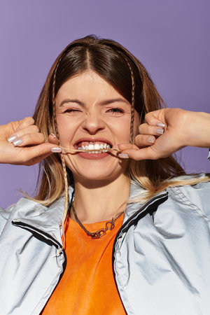 Bright summer moment as a young woman playfully smiles and poses, exuding carefree energy and charmの写真素材