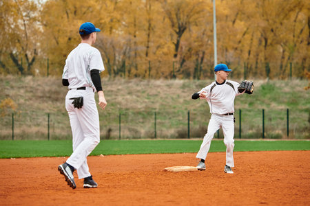 Energetic teenage boys showcase their skills while playing baseball on a well-maintained field.