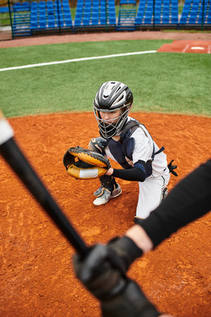Two boys passionately playing baseball on a vibrant green field during a warm afternoon.