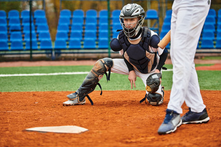 Two teens play baseball on a well-kept field, showcasing their skills.の写真素材
