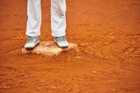 A player stands poised at home plate, ready to connect with the pitch