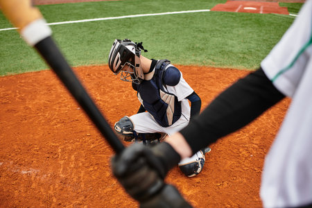 Two teenage boys engage in a thrilling baseball match, showcasing their athletic skills outdoors.の写真素材