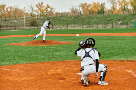 Two teenage boys engage in an exciting baseball game on a vibrant field, showcasing their skills.