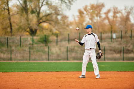 Excited young athlete showcases baseball skills while enjoying a sunny day on the field.の写真素材