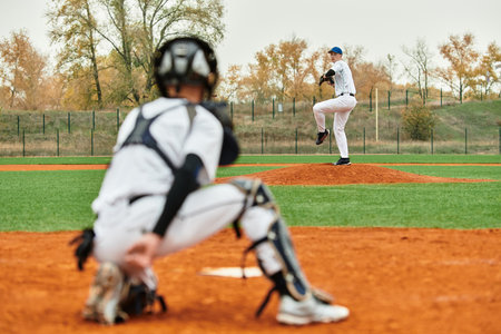 Two teenage boys engage in an exciting baseball game, showcasing their athletic skills on a field.の写真素材