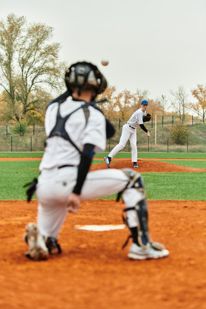 Teenage boys showcase their skills playing baseball on a lively green field during practice.