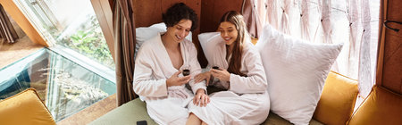Young couple shares a joyful moment, sipping drinks and embracing relaxation in a tranquil setting.