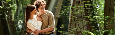 In a serene park, a young couple shares a lighthearted moment filled with love and laughter.の写真素材