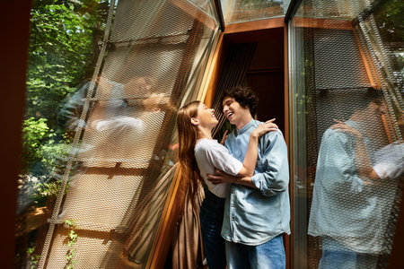 Two young individuals share a joyful embrace, savoring their time in a tranquil park atmosphere.の写真素材