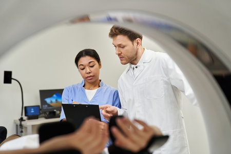 Healthcare professionals prepare a female patient for an MRI scan in a modern facility.