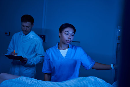A doctor and a nurse prepare a female patient for her MRI scan.の写真素材