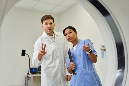 Two doctors collaborate on an MRI scan in a modern hospital, showcasing teamwork in health care.