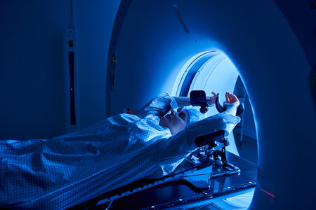 A woman undergoes MRI scanning in a cutting-edge hospital environment, focusing on health.の写真素材