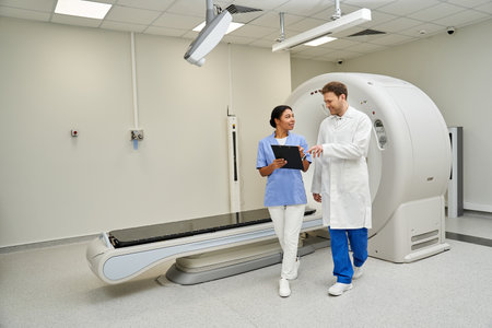 Two doctors consult on an MRI scan while working in a contemporary healthcare facility.