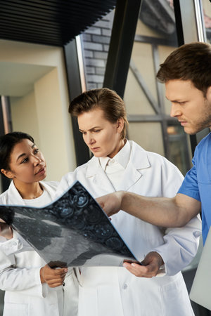Three multicultural doctors examine a medical report in a contemporary hospital environment.