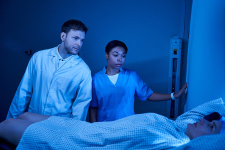 Healthcare professionals prepare a female patient for her MRI scan in a state-of-the-art facility.