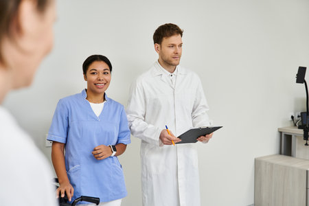 Handsome doctor and nurse support a female patient before her MRI scan in the hospital.の写真素材