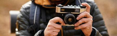 A senior woman explores the serene beauty of a vibrant forest while hiking among the trees.の写真素材