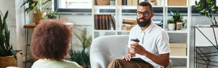 In a vibrant studio, a woman and a man converse during a interview, exchanging ideas.の写真素材