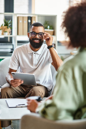 Candidates engage in dynamic discussions during a interview in a bright, stylish studio.の写真素材
