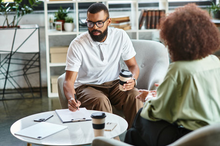 Young man and woman are involved in a dynamic interview at a contemporary studio space.の写真素材