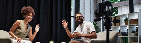 In a contemporary studio setting, a woman and a man communicate warmly during a interview.
