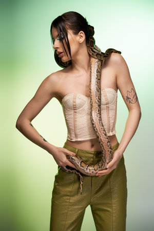 A young woman poses with a snake, embodying a blend of beauty and danger.