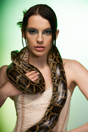 A young woman poses gracefully with a snake, exuding strength and beauty.