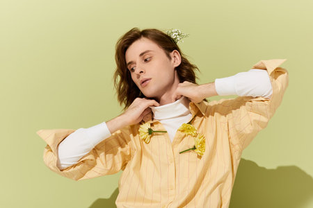 Young man with stylish features wears floral attire, showcasing his unique expression.