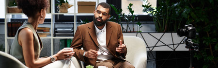 A woman and a man discuss employment opportunities in a contemporary studio setting.