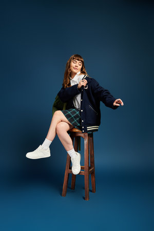 A beautiful female student playfully showcases her style and personality in a vibrant settingの写真素材