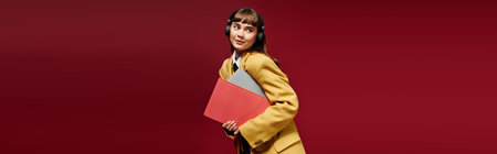 A cheerful young woman in headphones holds study materials in a lively environment.