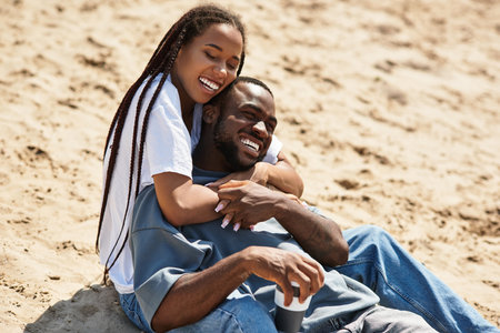 A young couple strolls hand in hand, laughing and enjoying each others company in nature.の写真素材