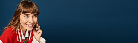 Beautiful female student smiles while studying, immersed in a joyful conversation.の写真素材