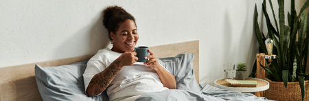 An African American woman enjoys her morning coffee in a stylish bedroom filled with natural light,...