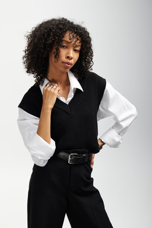 A young beautiful woman poses elegantly in stylish business attire, exuding confidence and charisma.の写真素材