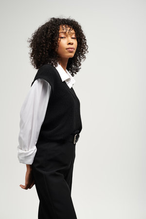 Charming young woman in stylish business attire exudes elegance and professionalism.の写真素材