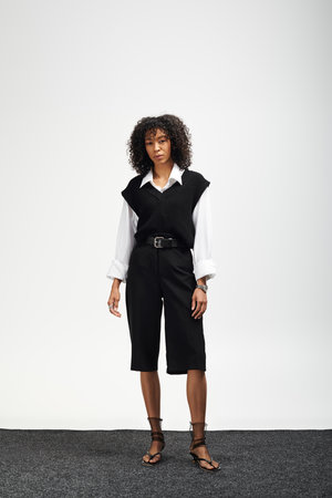 A young beautiful woman poses confidently in chic business attire, showcasing elegance and poise.の写真素材