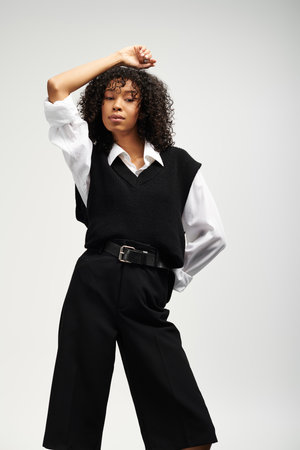A young beautiful woman exudes elegance while showcasing her confidence in business attire.の写真素材