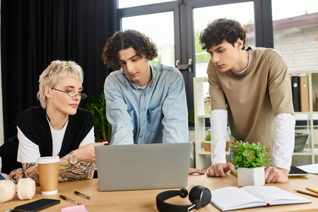 Three young professionals engage in a collaborative work session at their office, sharing ideas.の写真素材