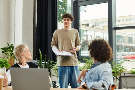 A dedicated youth engages colleagues with a thoughtful presentation in a contemporary workspace.