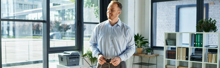 Handsome young professional engages with colleagues in a bright, green setting.