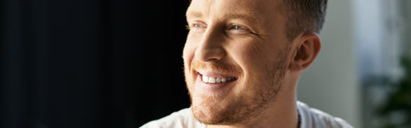 Confident young professional focused on his tasks while enjoying natural light and a calm atmosphereの写真素材