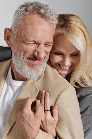 A stylish older couple shares a joyful moment, showcasing their love and connection.の写真素材