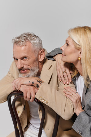 Senior couple dressed fashionably exudes romance and connection in a warm, intimate moment.の写真素材