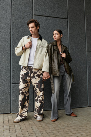 A couple in stylish outfits enjoys their time together in an urban setting.