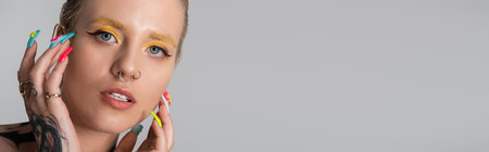 Beautiful woman showcases her trendy style through colorful makeup and expressive accessories.のeditorial素材