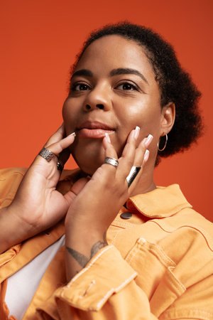 A stylish plus size woman poses confidently in an autumn-inspired outfit, showcasing individuality.